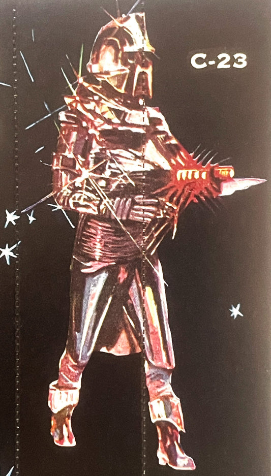 Vintage vending card labeled "C-23" showing a red and gold armored sci-fi warrior figure with helmet and weapon against black