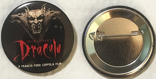 Front and back of a round pin button featuring a demonic face with horns and "Dracula" text in red, labeled "A Francis Ford C