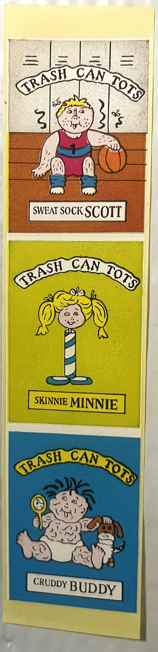 Three sticker panels showing cartoon characters labeled Sweat Sock Scott, Skinny Minnie, and Cruddy Buddy in "Trash Can Tots"