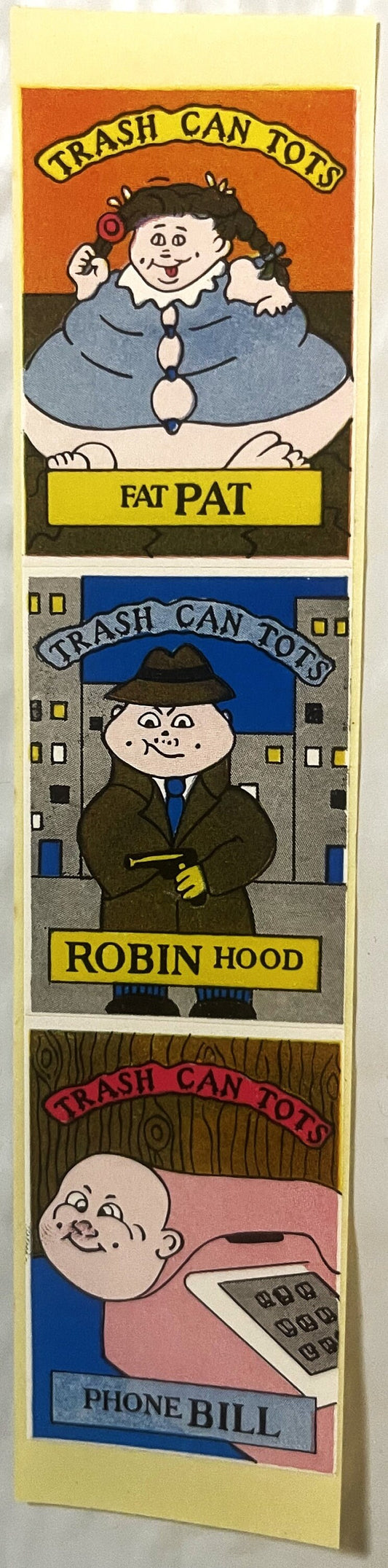 Three stacked Trash Can Tots sticker cards featuring cartoon characters Fat Pat, Robin Hood, and Phone Bill on orange, gray,