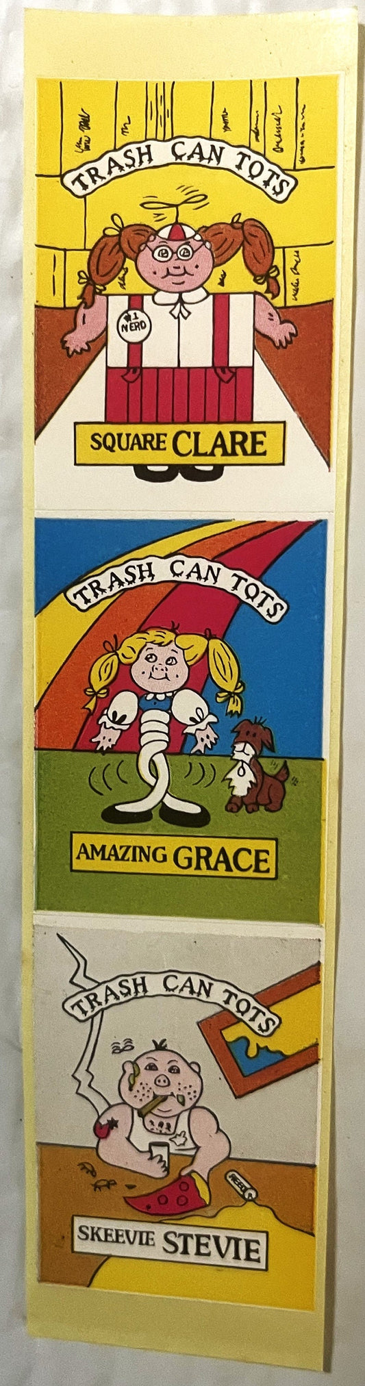 Three colorful sticker panels labeled "Trash Can Tots" featuring cartoon characters: Square Clare, Amazing Grace, and Skeevie