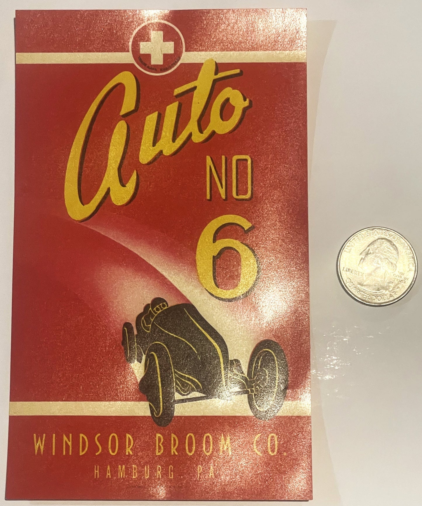 Vintage red broom label with yellow "Auto No 6" text, racing car illustration, and Windsor Broom Co Hamburg PA imprint, shown