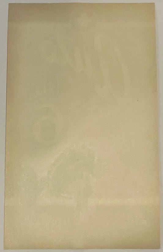 Blank cream-colored vintage broom label, back side shown, with subtle wear and age spots visible