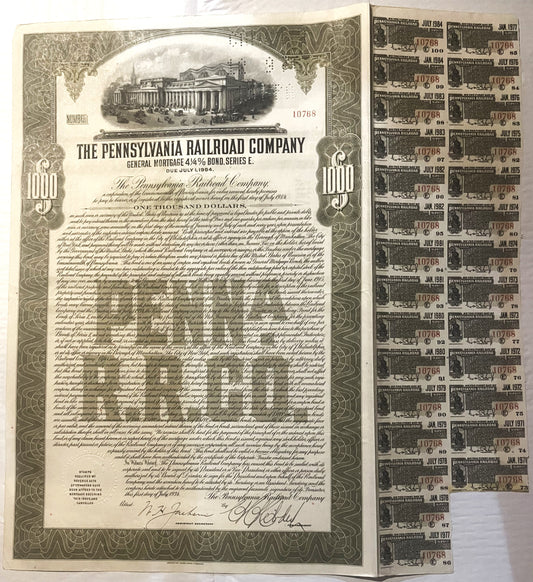 Vintage 1934 Pennsylvania Railroad $1000 bond certificate with attached coupon sheets showing dates from 1971-1984, displayed