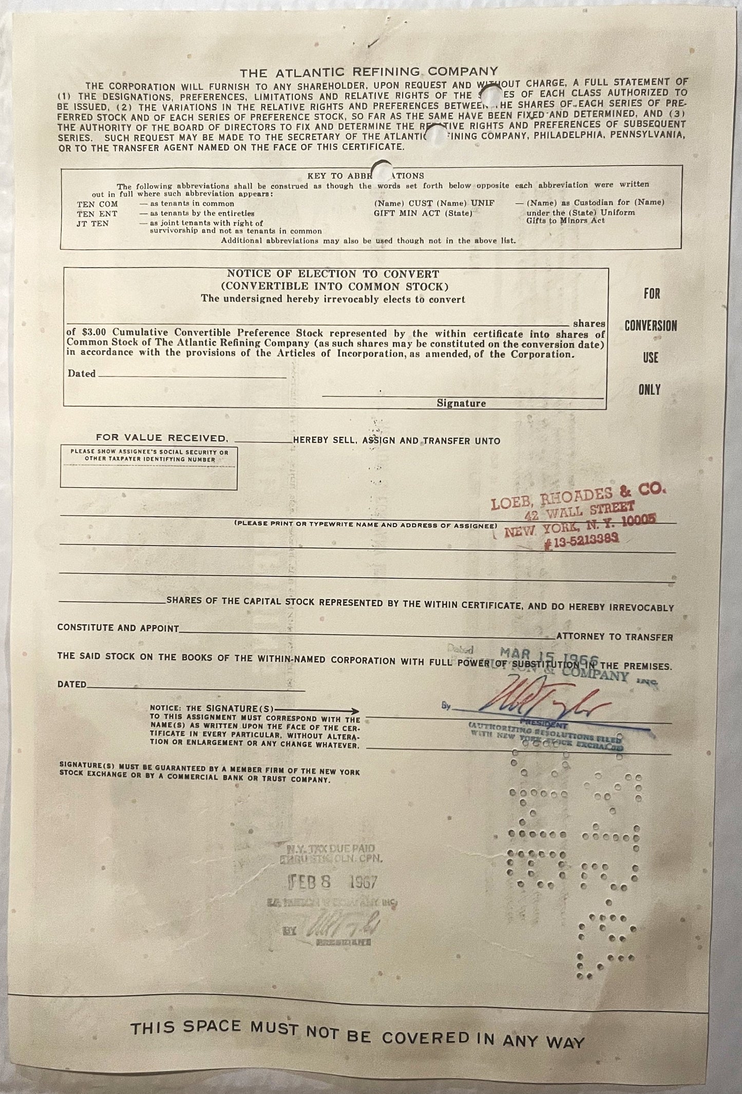 Yellowed 1960s Atlantic Refining Company stock certificate with printed text, conversion notice, and red stamp from Loeb, Rho