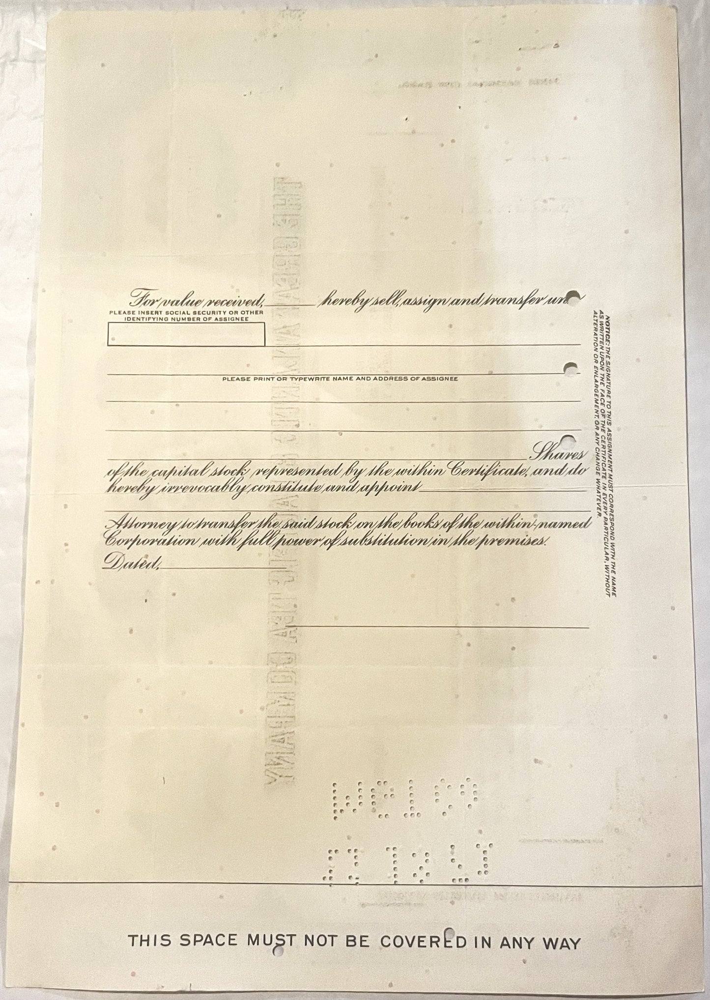 Blank vintage stock certificate form with ornate cursive text and printed instructions, cream-colored paper with braille at b