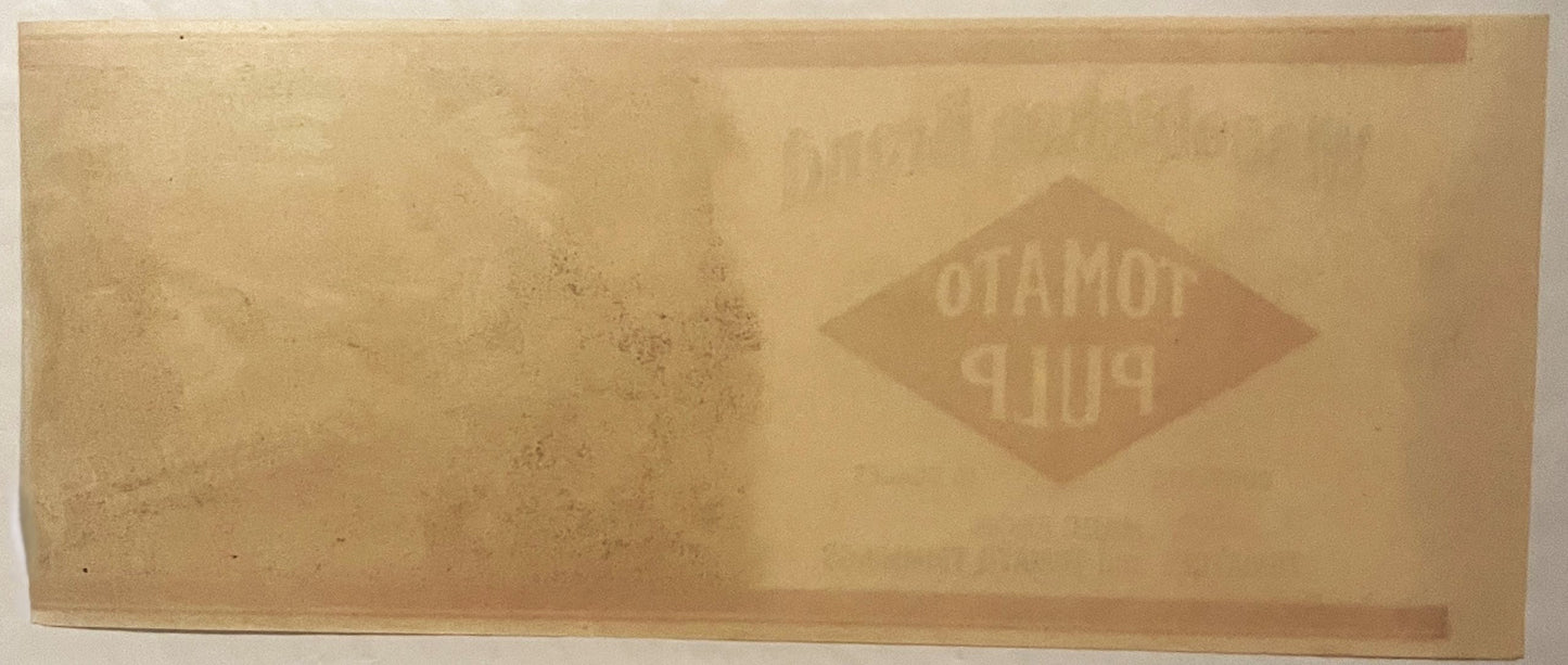 Faded vintage tomato pulp can label with embossed diamond-shaped logo reading "Wissahickon" on tan paper background