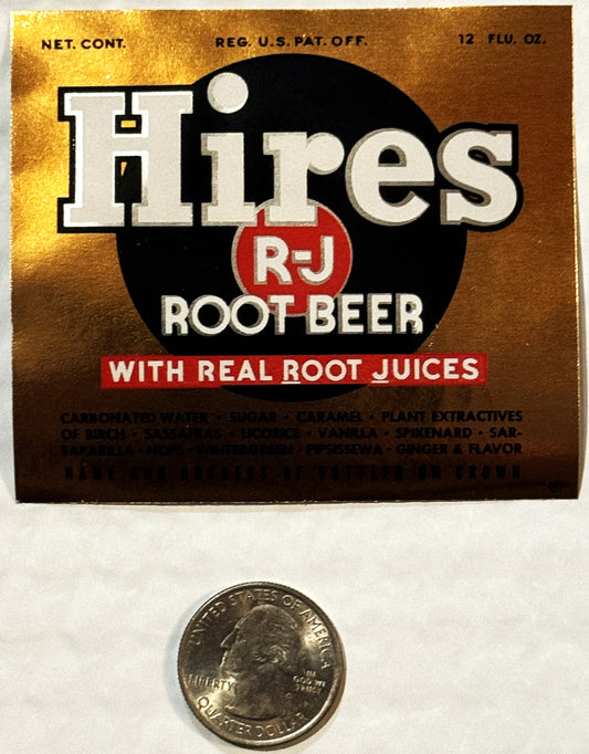 Vintage Hires R-J Root Beer label with gold background and black circle logo, shown next to quarter for scale