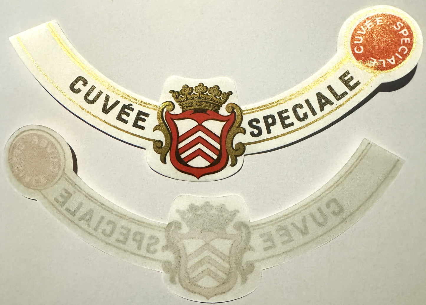 Antique French wine label with gilt-edged cream and black ribbons, red heraldic crest with crown, text reading "Cuvée Spécial