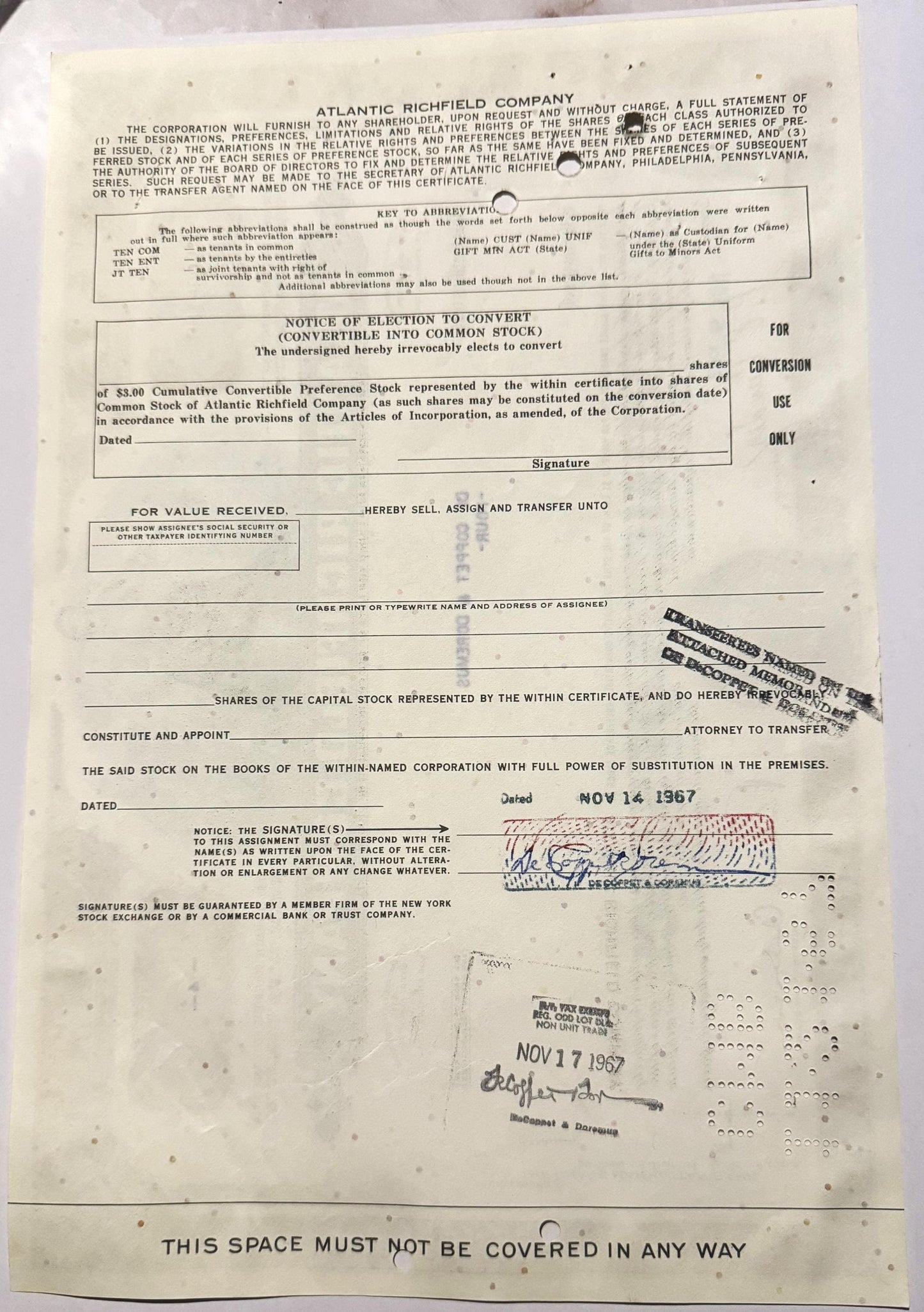 Cream-colored Atlantic Richfield convertible stock certificate with printed text, signature, and dated stamps in blue an