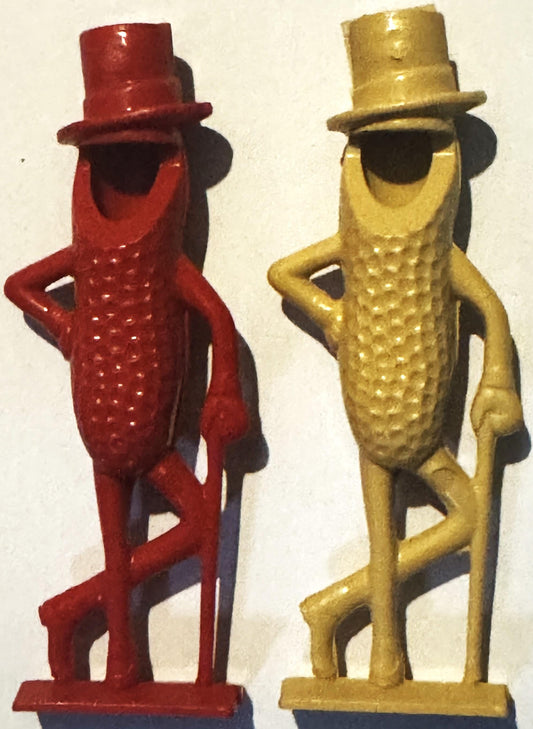 Two vintage Mr. Peanut plastic figurines in red and gold with top hats, standing pose, textured bodies with arms on hips