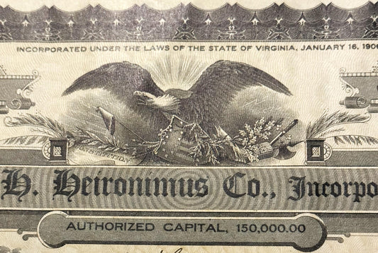 Close-up of ornate stock certificate header showing eagle with spread wings, decorative border, and text "S.H. Heironimu