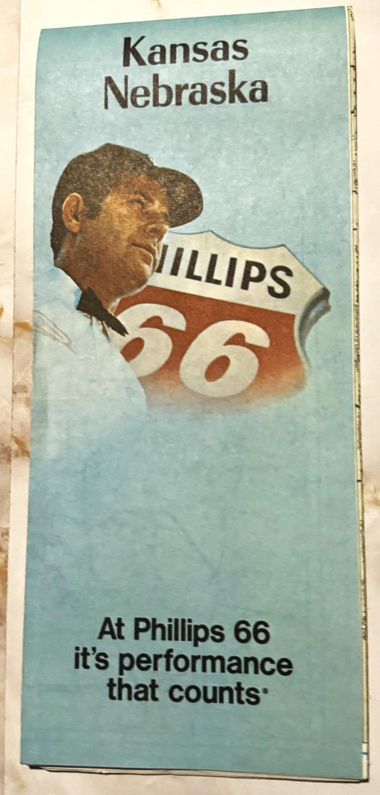 Vintage Phillips 66 gas station map cover featuring Kansas and Nebraska with a man in a cap, red and white shield logo, light