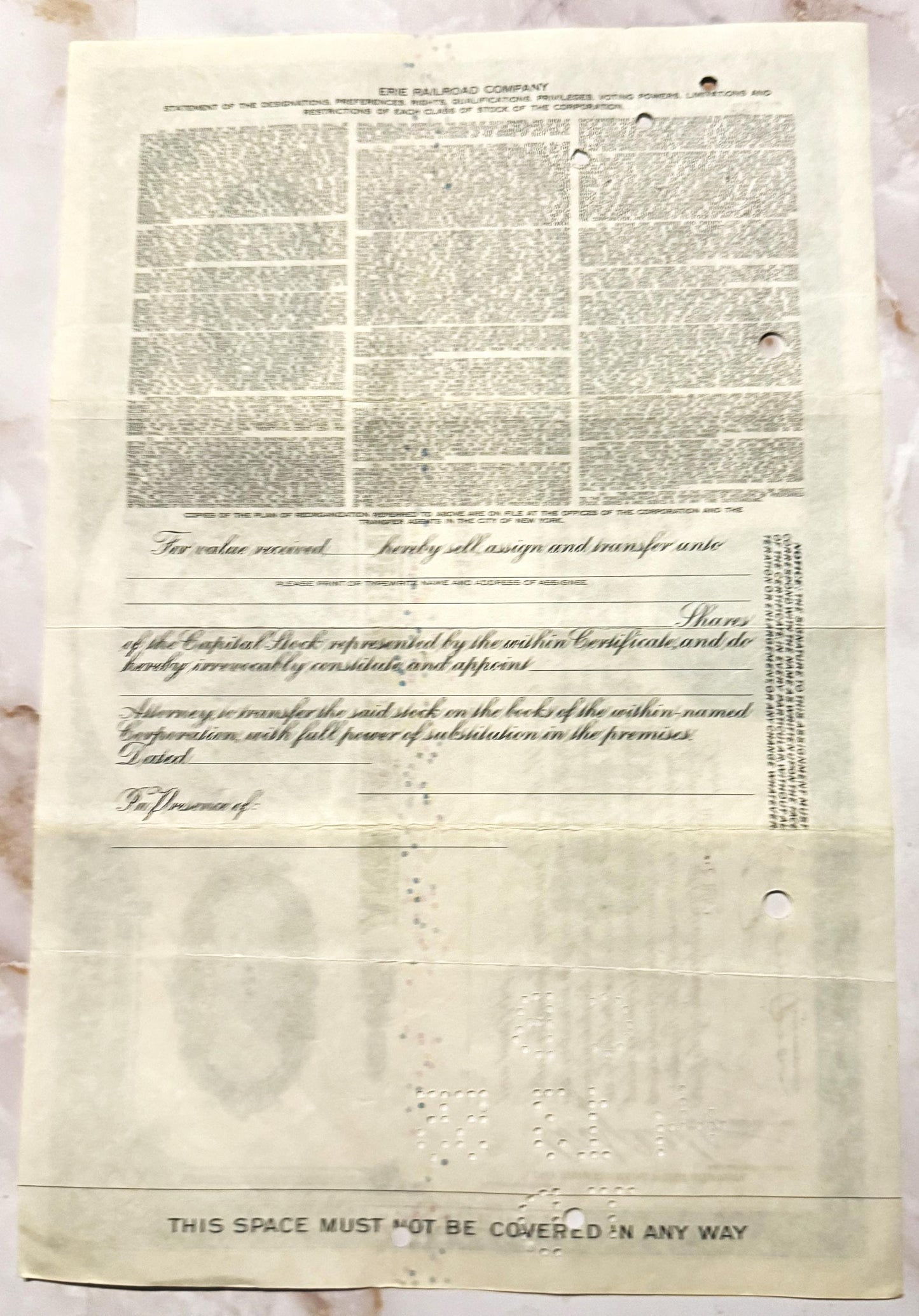 Cream-colored Erie Railroad stock certificate from mid-20th century with printed text and decorative vignette, showing age sp