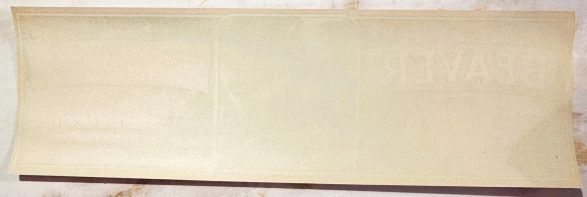 Blank cream-colored vintage crate label with dark brown stripe along bottom edge, shown flat against white background