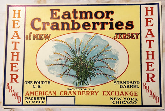 Vintage cranberry barrel label with yellow background, red oval botanical illustration, and "Heather Brand Eatmor Cranberries