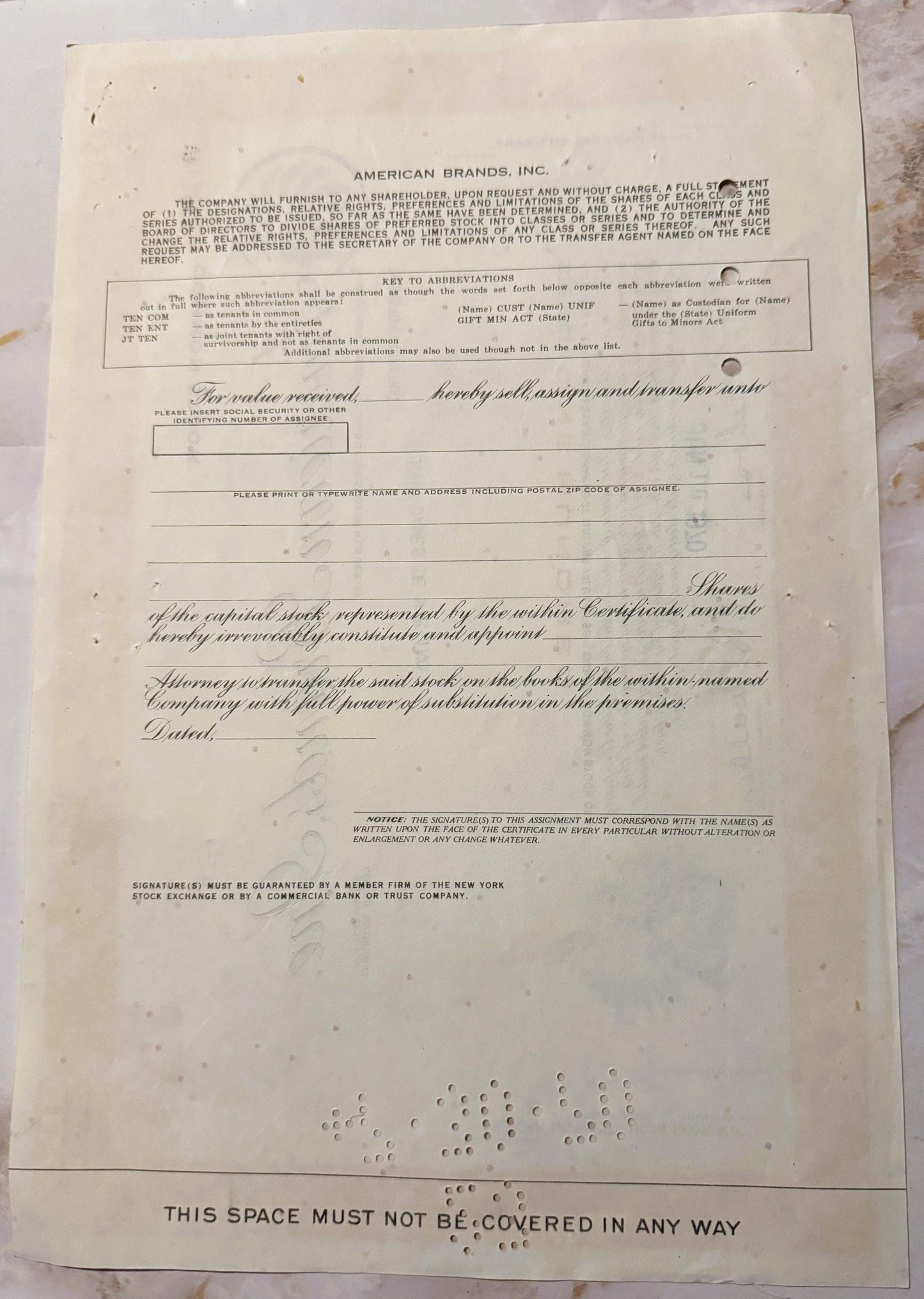 Vintage American Brands Inc stock certificate with ornate script and decorative vignette, printed on cream paper with visible