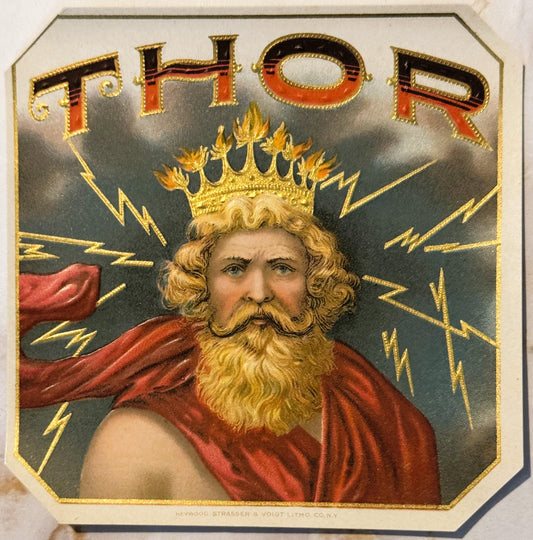 Gold-embossed vintage cigar label featuring bearded man with crown and red cape surrounded by lightning bolts, text reads "TH