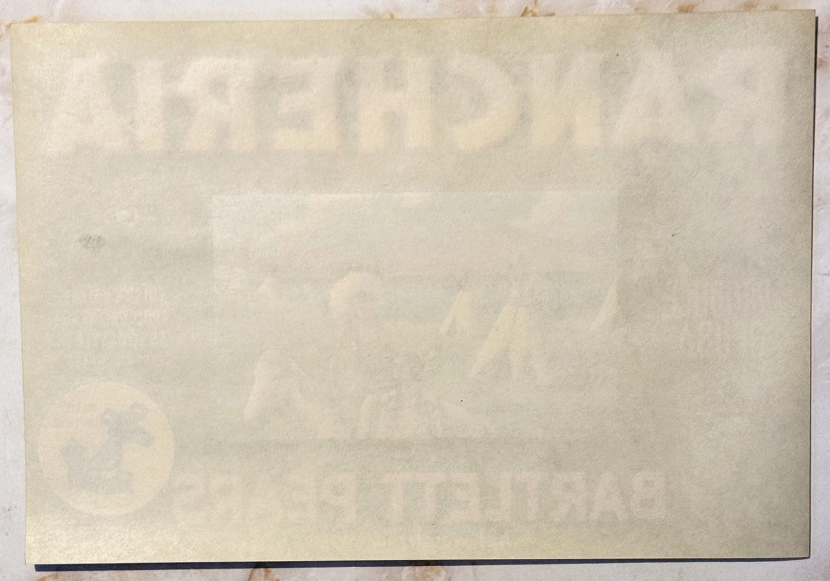 Aged cream-colored vintage fruit crate label with faint printed text and Native American teepee imagery, showing wear and dis