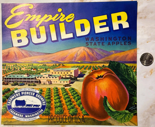 Vintage Empire Builder Washington State apples crate label featuring colorful orchard landscape, factory building, and large