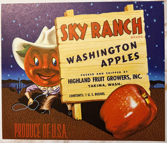 Vintage Sky Ranch brand Washington apples crate label featuring a smiling anthropomorphic apple character in cowboy attire