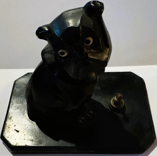 Black cast metal Art Deco bulldog inkwell with white eyes and brass details, mounted on silvered rectangular base, photograph