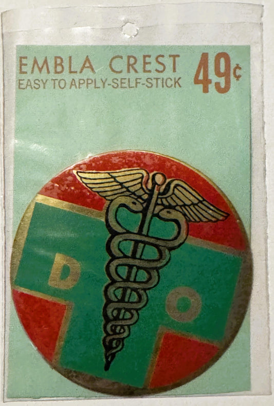 Unopened vintage Embla Crest self-stick decal featuring caduceus medical symbol on red and green circular background, priced