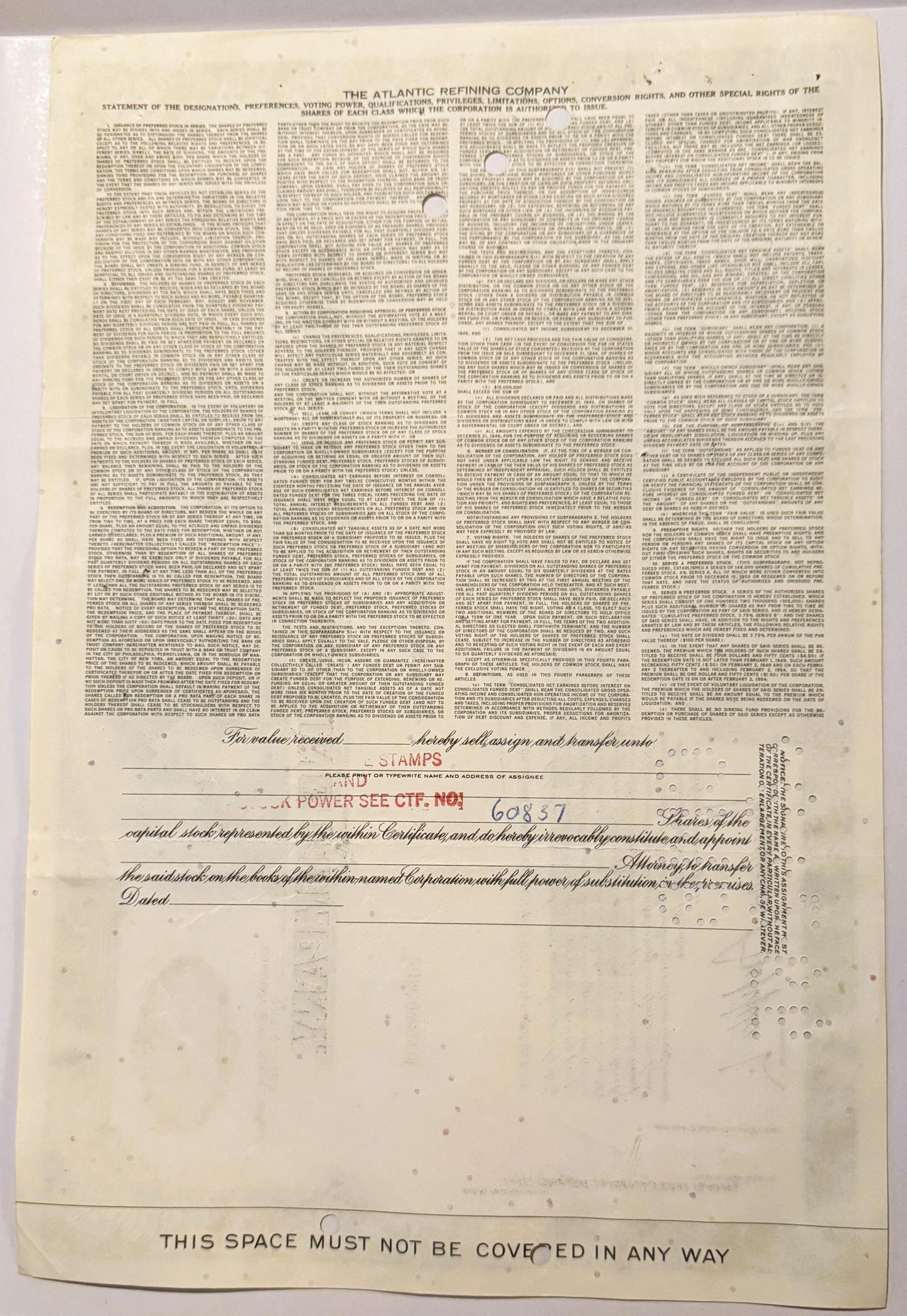 Cream-colored vintage stock certificate from Atlantic Refining Company with dense printed text in four columns and transfer a