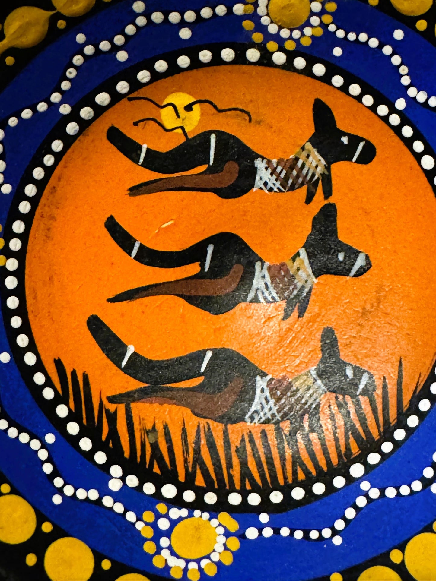 Hand-painted ceramic dish with three black kangaroos on orange background surrounded by white and yellow dot patterns on blue