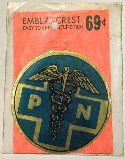 Vintage self-stick emblem crest decal priced at 69 cents, featuring winged caduceus medical symbol on blue and gold circular