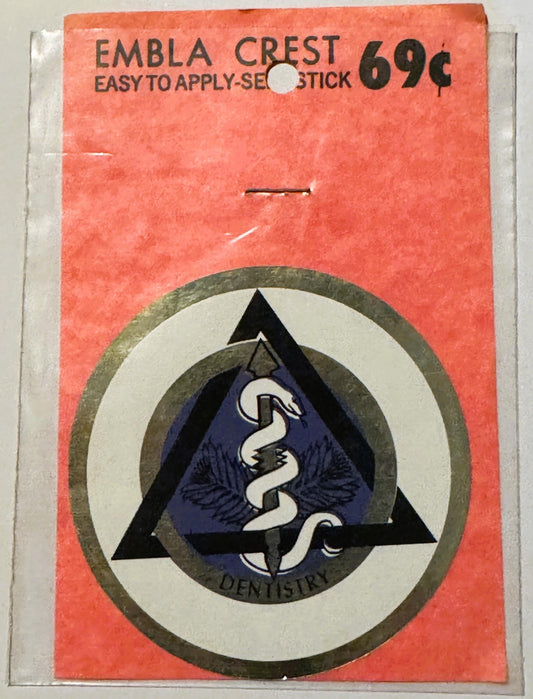 Vintage red package labeled "Embla Crest Easy to Apply Seal Stick 69¢" with circular dental emblem featuring a snake and staf