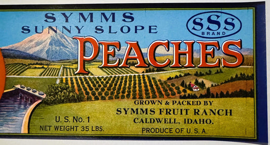 Vintage peach crate label with mountain and orchard scene, red lettering, SSS Brand logo, Symms Fruit Ranch Caldwell Idaho te