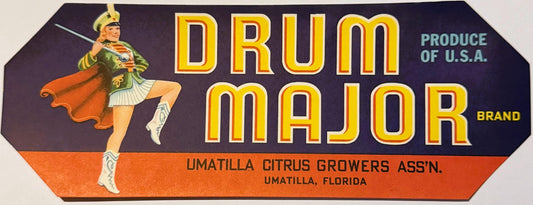 Vintage Drum Major brand citrus crate label featuring a gold-helmeted majorette in green uniform and orange cape against dark