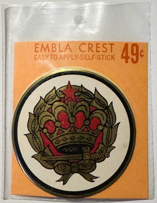 Unopened orange and clear packaging for a self-stick Embla Crest decal priced at 49 cents, featuring a red and gold crown emb