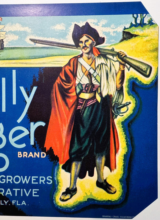 Vintage fruit crate label featuring a pirate in tricorn hat and red cape holding a telescope, with yellow border and blue
