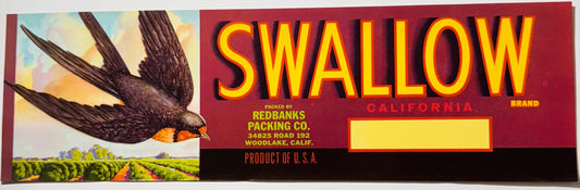 Vintage fruit crate label with yellow "SWALLOW" text on red background, flying swallow illustration, agricultural field scene