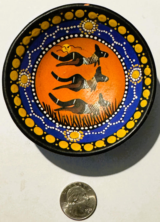 Hand-painted ceramic dish featuring three black kangaroos on orange background surrounded by blue and gold dotted border, sho