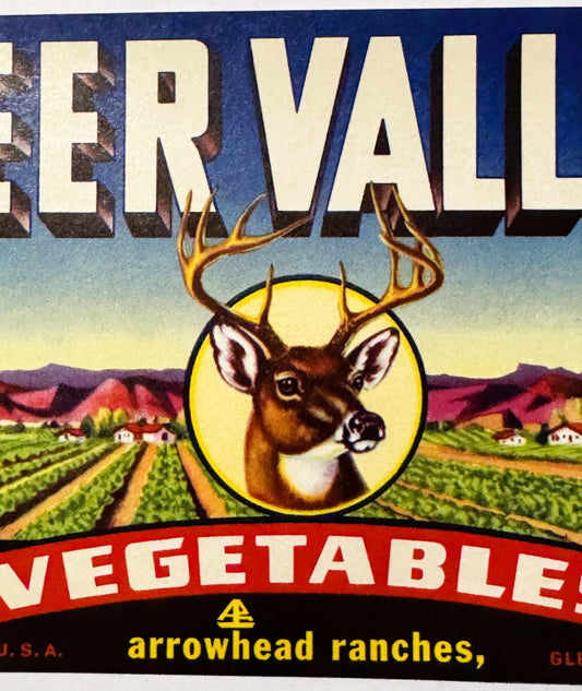 Vintage produce crate label featuring a buck's head in a yellow circle with "Deer Valley Vegetables" text and agricultural la