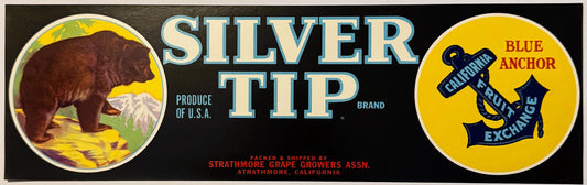 Vintage fruit crate label with brown bear and snowy mountain on left, "Silver Tip" text center, blue anchor logo on yellow ri