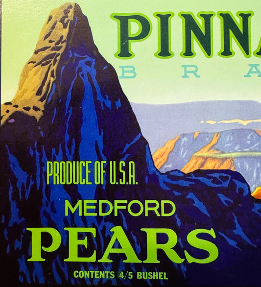 Vintage Pinnacle Brand Medford pears crate label featuring a dramatic blue and yellow mountain rock formation against a green