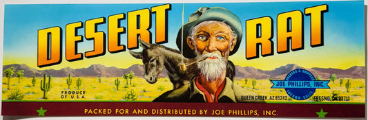 Vintage Desert Rat fruit crate label featuring bearded prospector with donkey in desert landscape, yellow and blue text, Joe