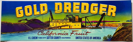 Vintage fruit crate label with yellow "Gold Dredger" text, gold dredging boat on turquoise water, colorful landscape backgrou