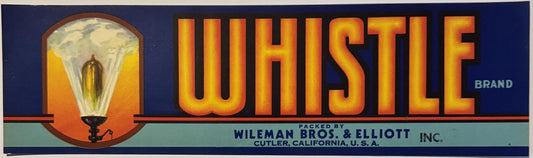 Vintage Whistle brand crate label with brass steam whistle illustration and gold lettering on dark blue background, packed by