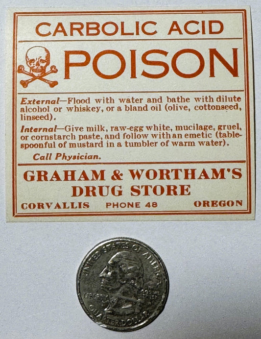 Vintage poison label with skull and crossbones, treatment instructions, and Corvallis Oregon drug store details, displayed ne