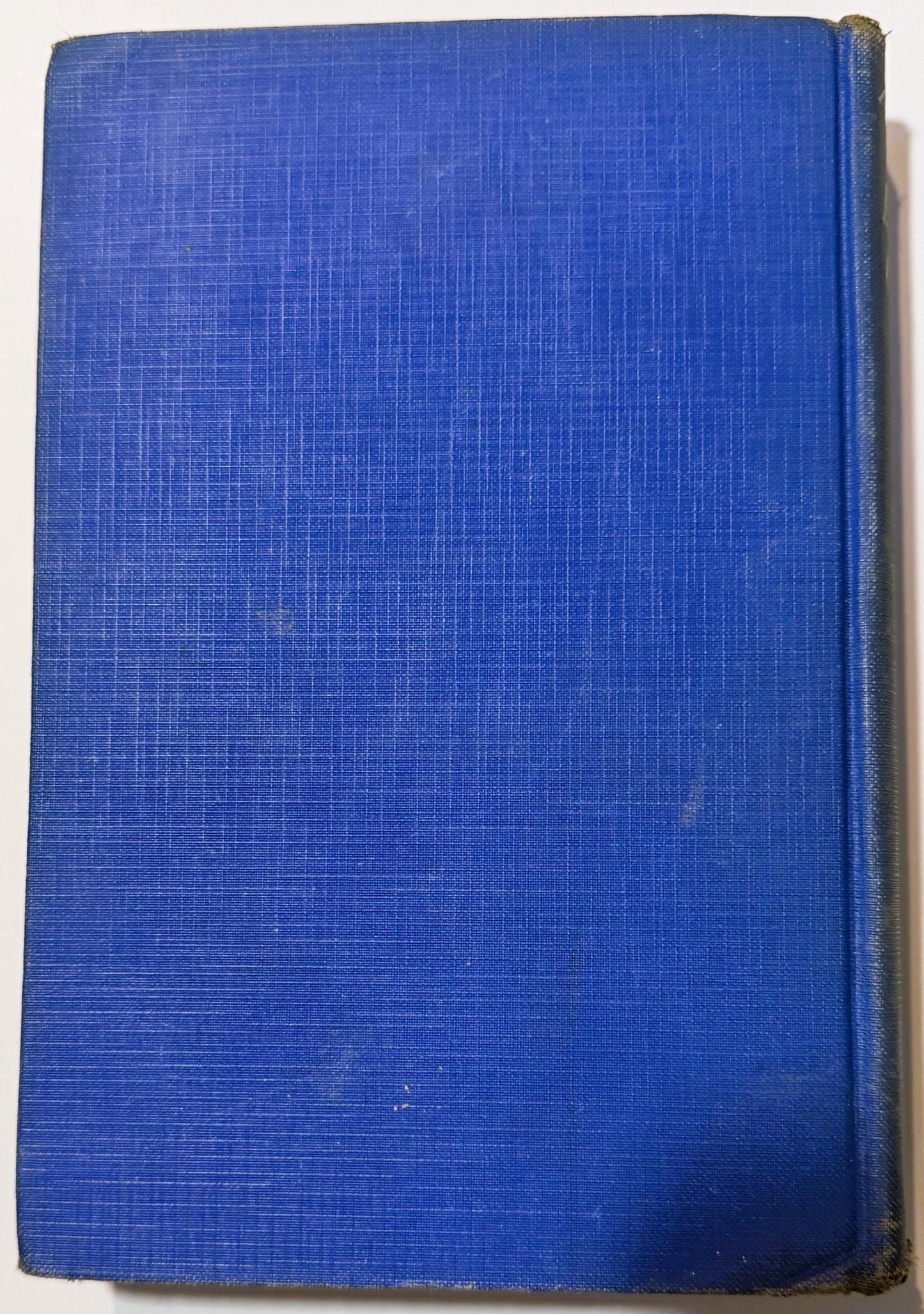 Blue cloth hardcover book with textured linen binding, front cover shown against white background