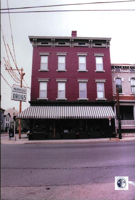 Brick storefront of Morwessel Drugs in Covington KY with striped awning, vintage pharmacy sign visible on left side