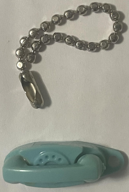 Teal plastic rotary phone charm with silver beaded chain and teardrop pendant, displayed on white surface