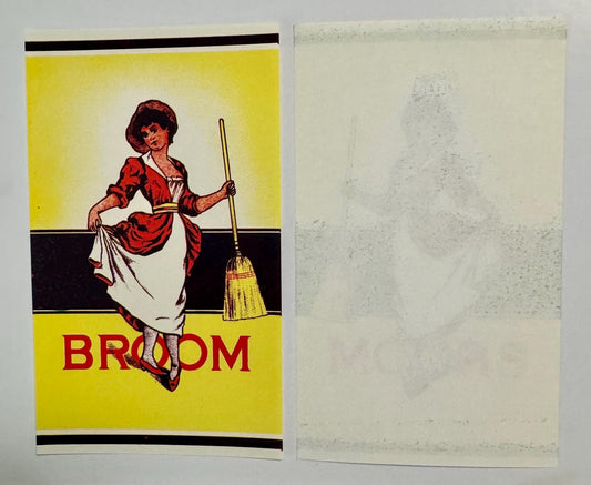 Vintage broom label showing front and back sides: yellow and black striped design with red-dressed woman holding broom, red "