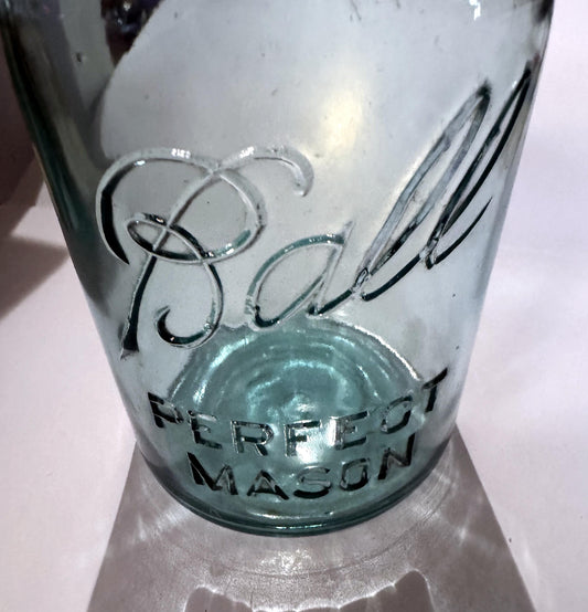 Close-up of the embossed Ball script on the blue glass, with no underline beneath it, above PERFECT MASON in block letters