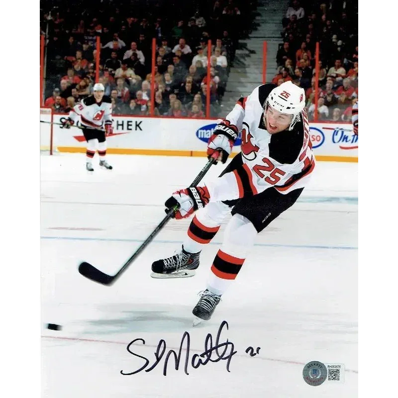 Jersey Devils autographed hockey puck with No 25 in action for collectors and fans